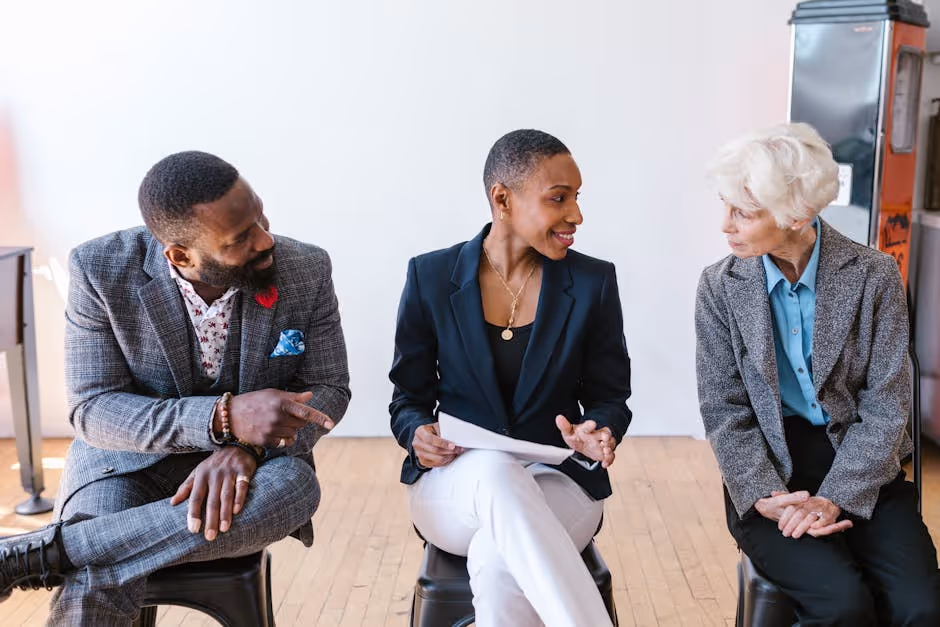 a diverse group of investors discussing a property portfolio - short term real estate loan