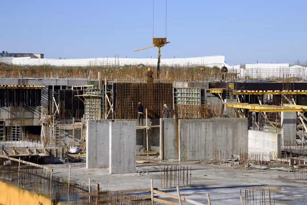 Construction site with workers and equipment showing active development project - private lender construction loans