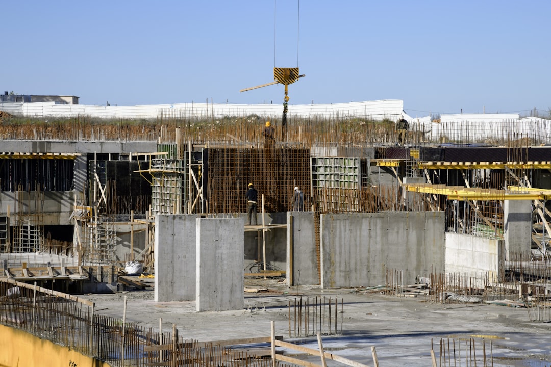Construction site with workers and equipment showing active development project - private lender construction loans