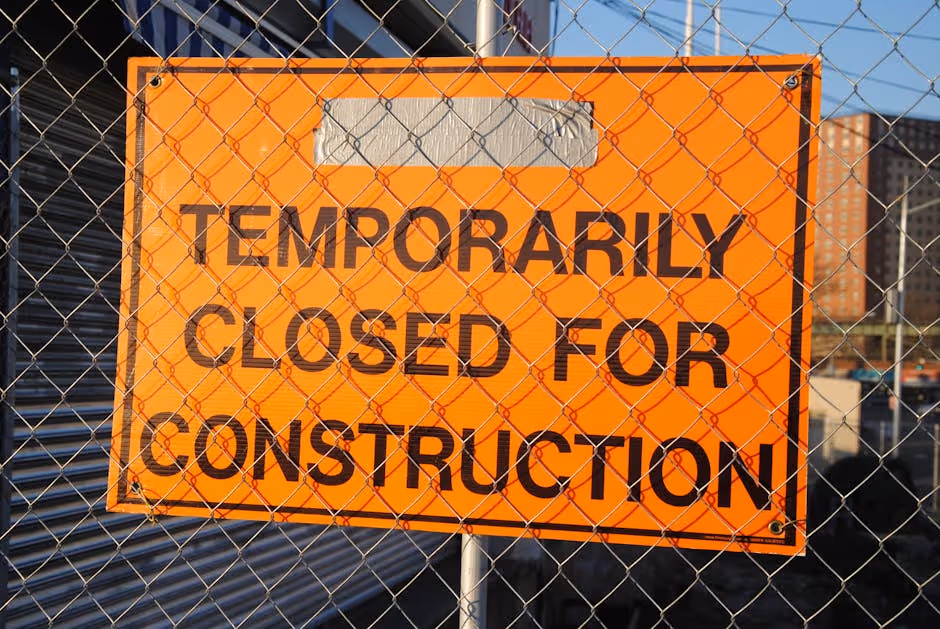 construction site with "Work Stopped" sign - Construction completion financing