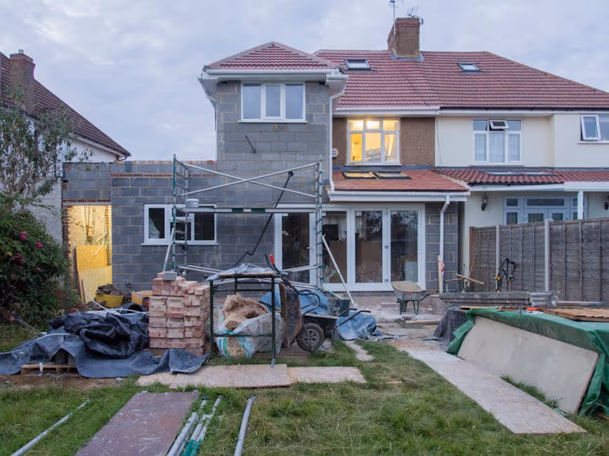 Image of a house being renovated with scaffolding and construction materials around it - hard money loan