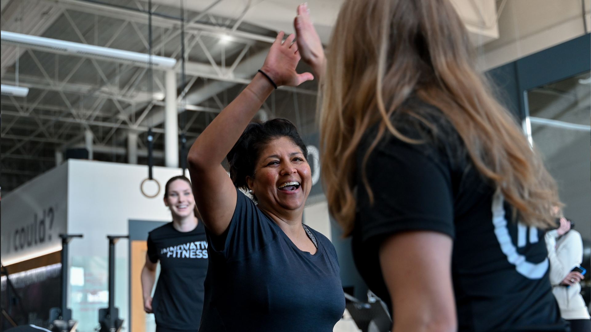 Interior shot of Innovative Fitness gym with a personal trainer and client 