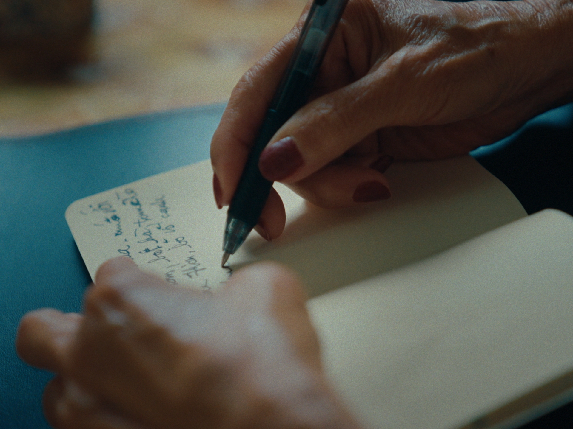 A recipe being handwritten into the notebook