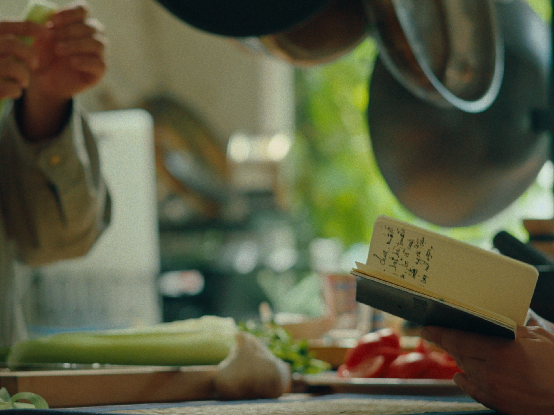 The notebook held open in the kitchen, a handwritten recipe inside