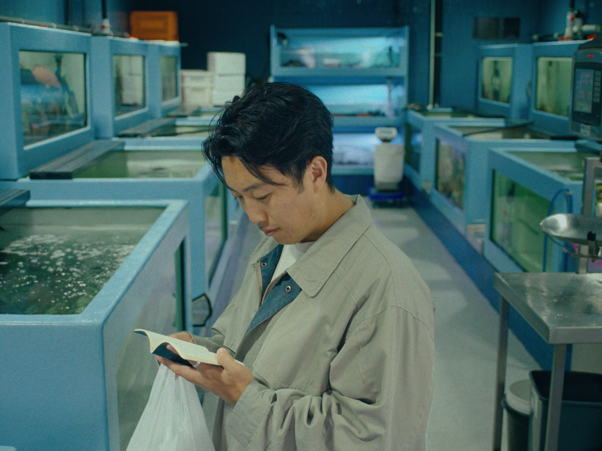 Reading the notebook at a seafood market