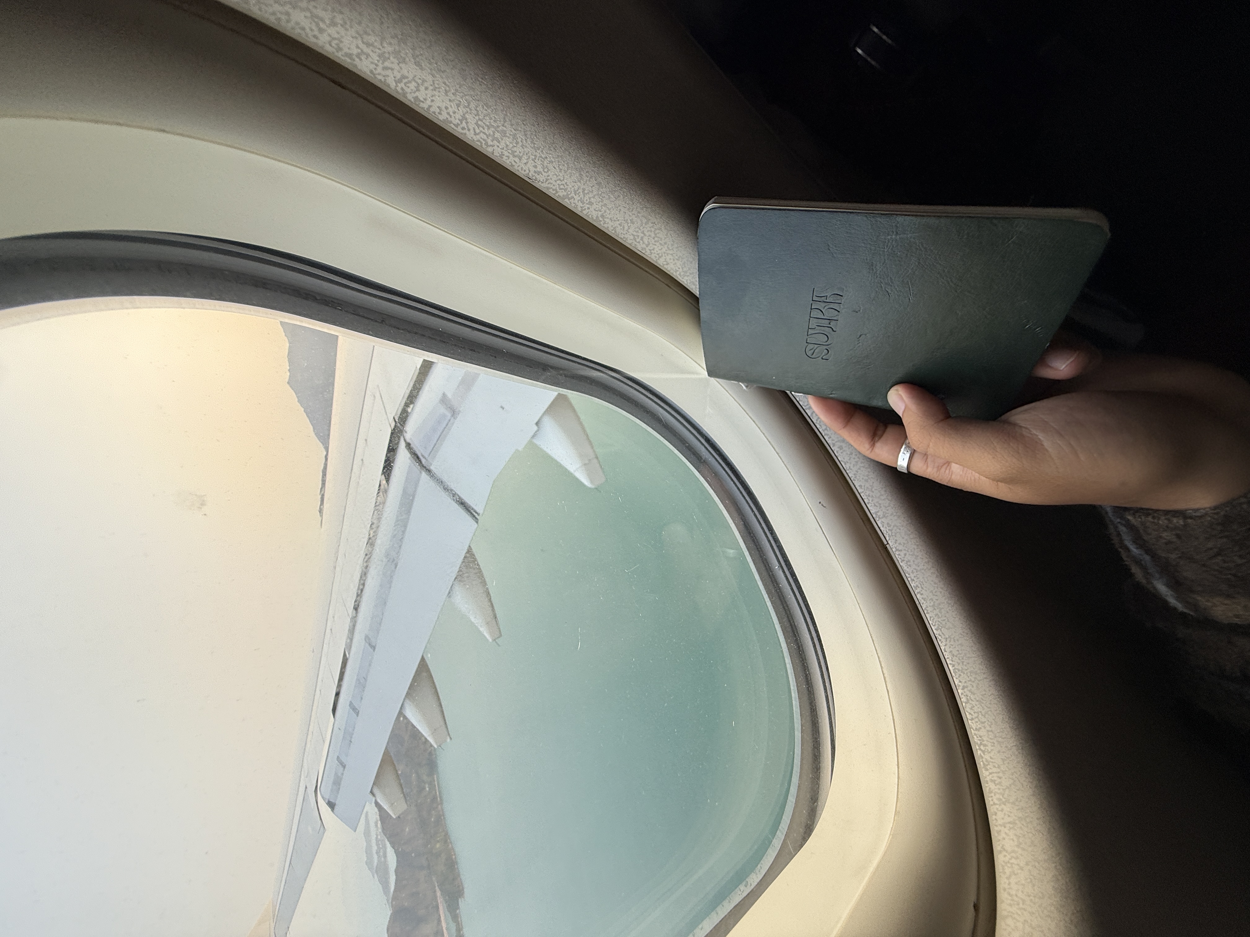 The notebook held up to a plane window