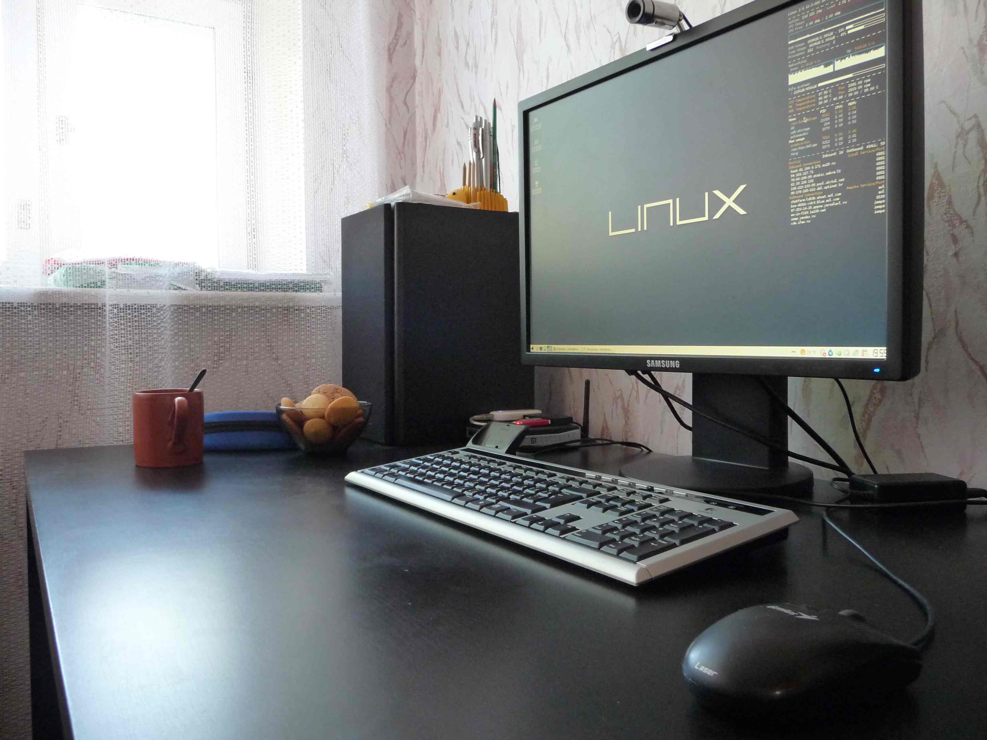 Anton’s ascetic work desk at home in 2010 with an early LED monitor and Linux-based OS installed.