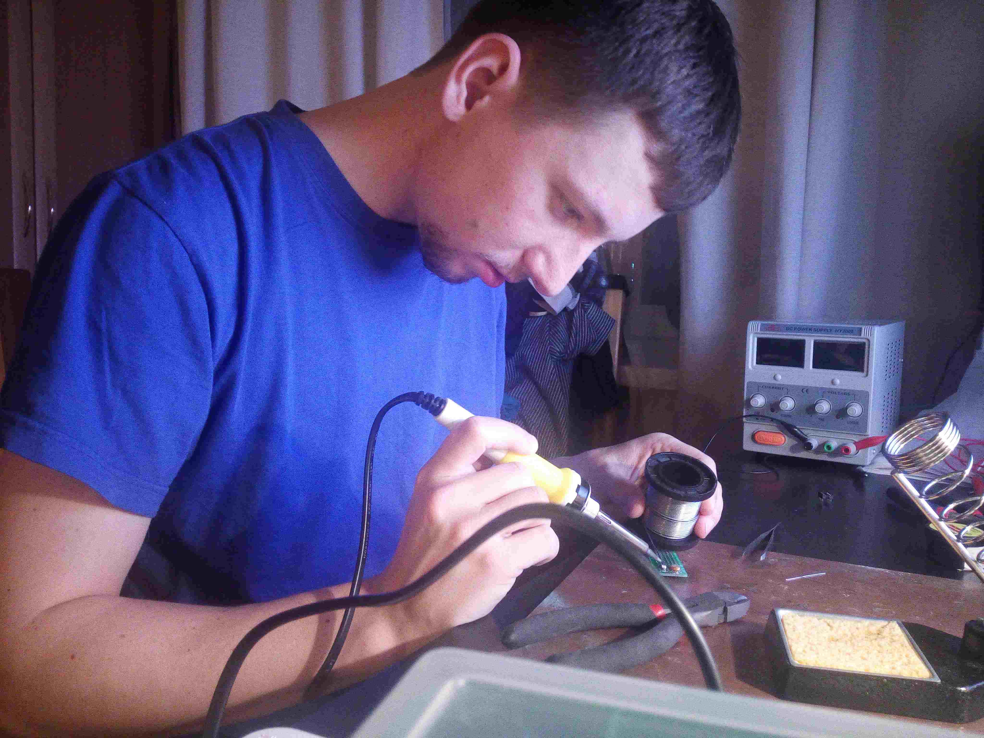OctoProctor CTO experiments with DIY assembly at his home, surrounded by coils, schemes, small particles, and a welding machine