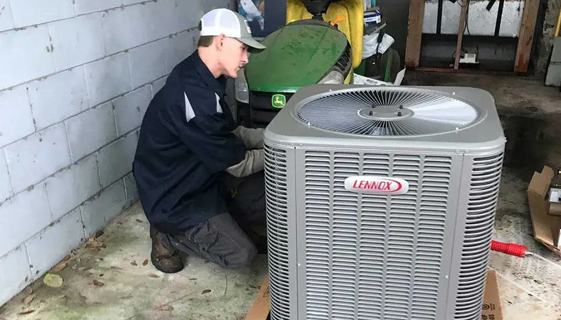 FL HVAC Services technician installing a new Lennox outdoor AC unit