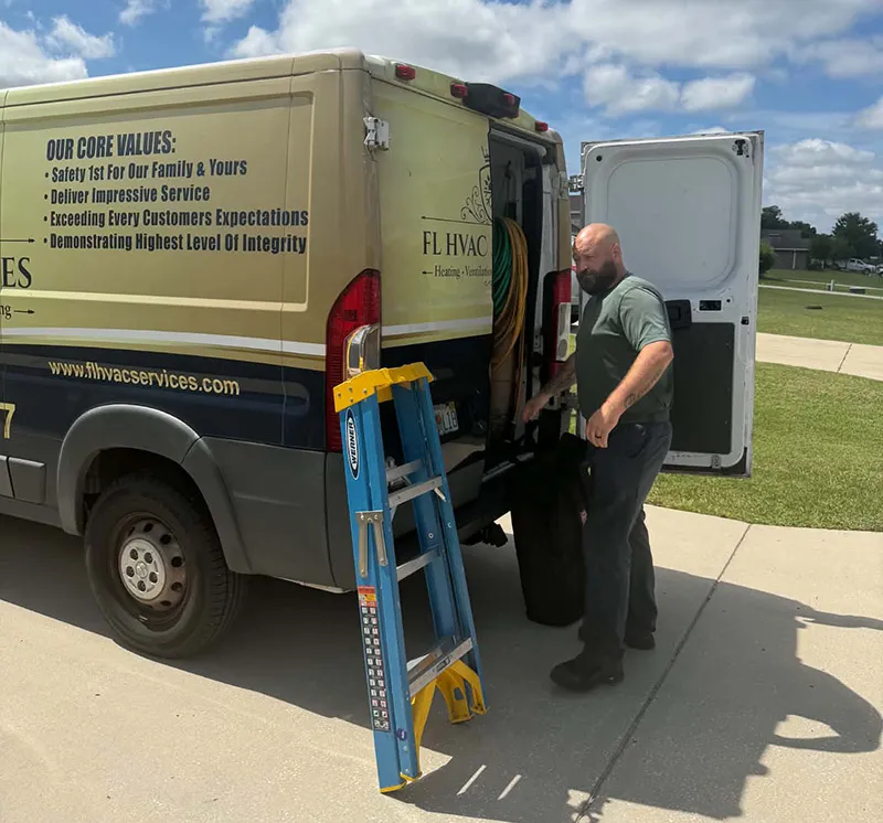FL HVAC Services technician unloading the service van for an AC visit in Ocala, FL