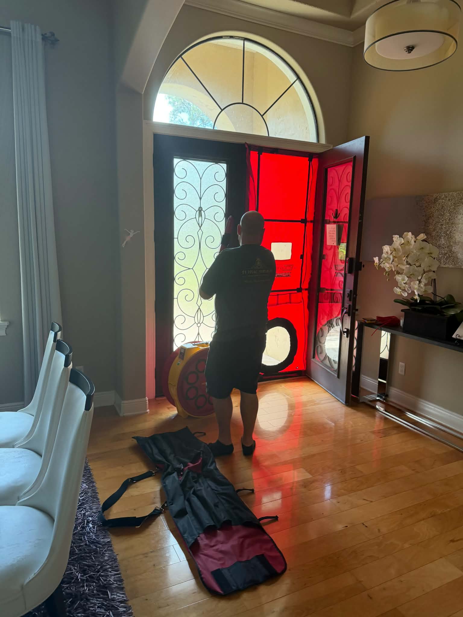 FL HVAC Services technician setting up a blower door test to measure air leaks
