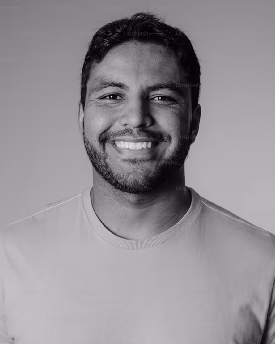 Smiling person in white shirt, black and white headshot portrait