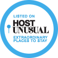 Circular badge reading Listed on Host Unusual Extraordinary Places to Stay with person icons.