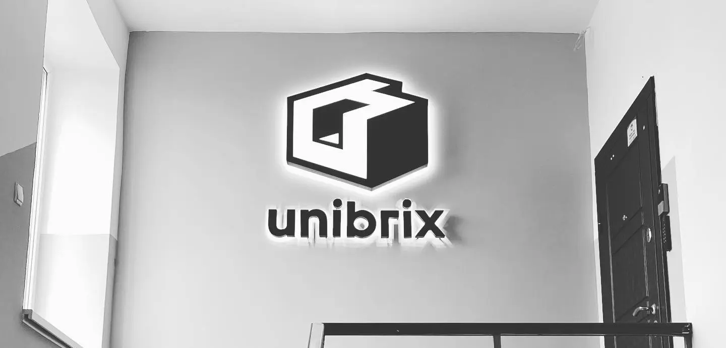  Unibrix brand sign on office wall — craftsmanship and modular software culture