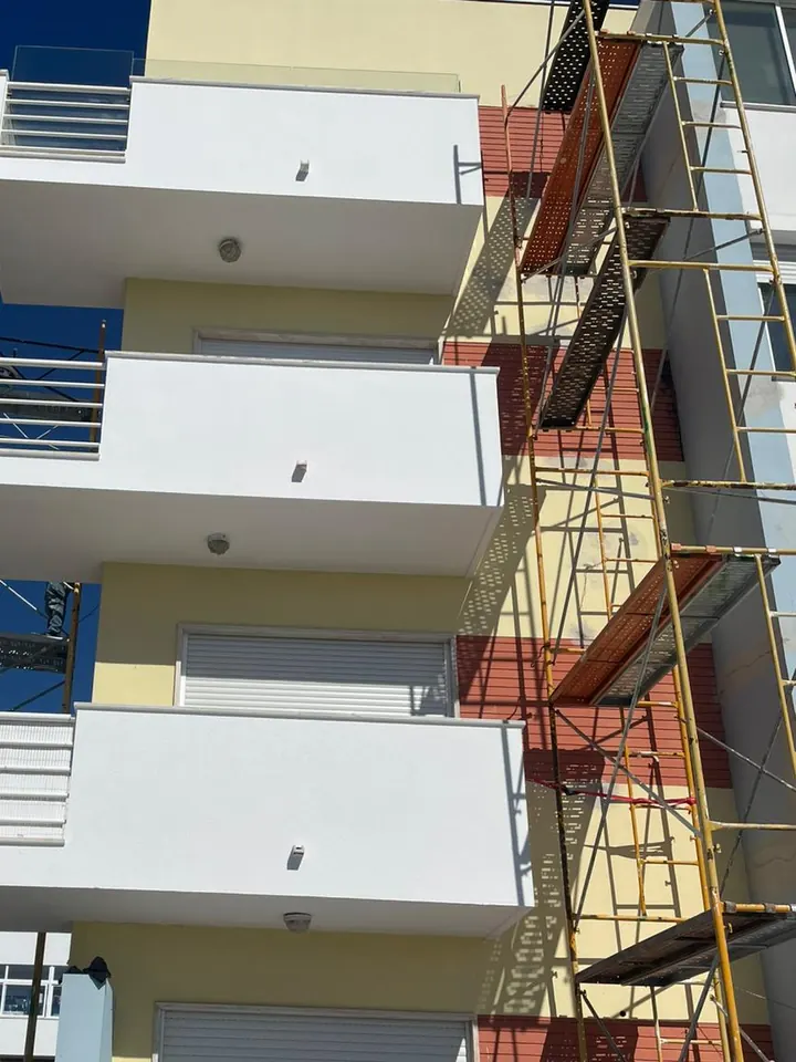 The building façade after painting, with no holes visible
