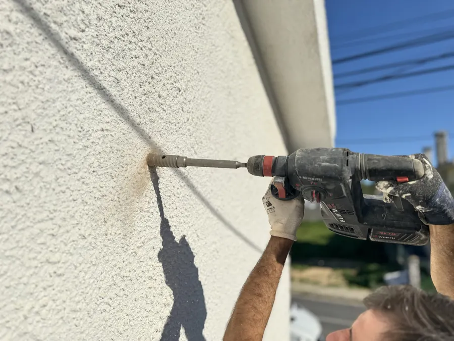 Drill making a 37 mm hole in the façade