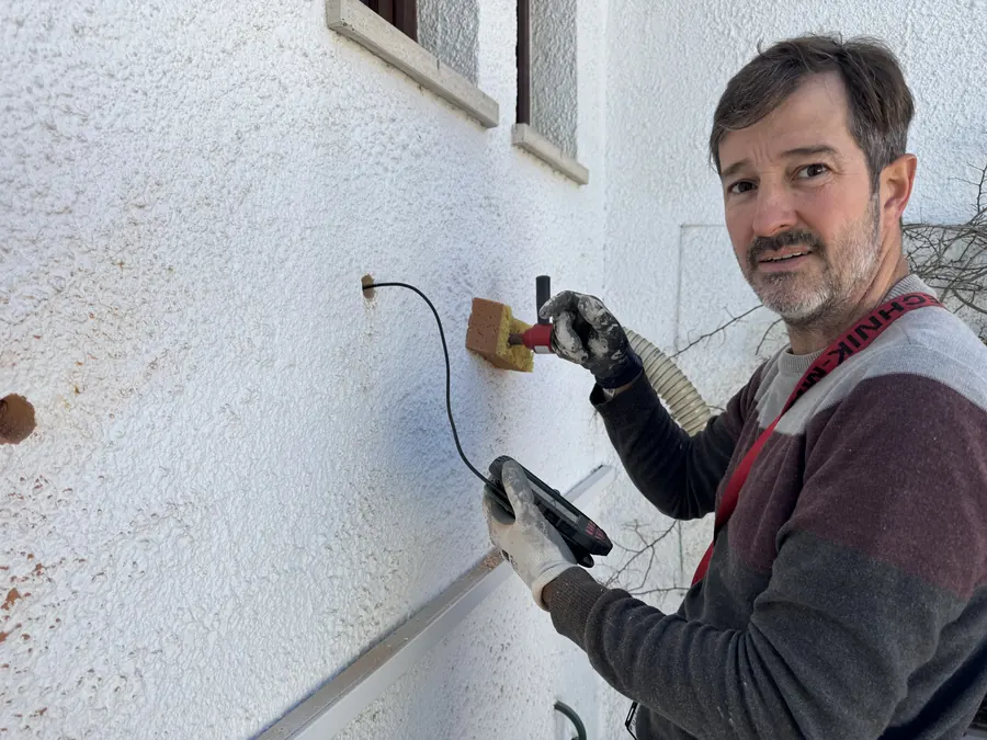 EnergyEase installer looking inside a wall with an inspection camera