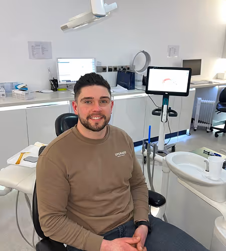 Neo Orthodontics | A man sitting in a chair in a dental surgery.