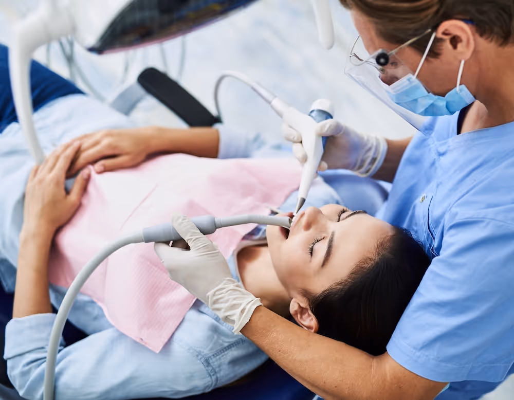A woman laying down in a dentist chair.