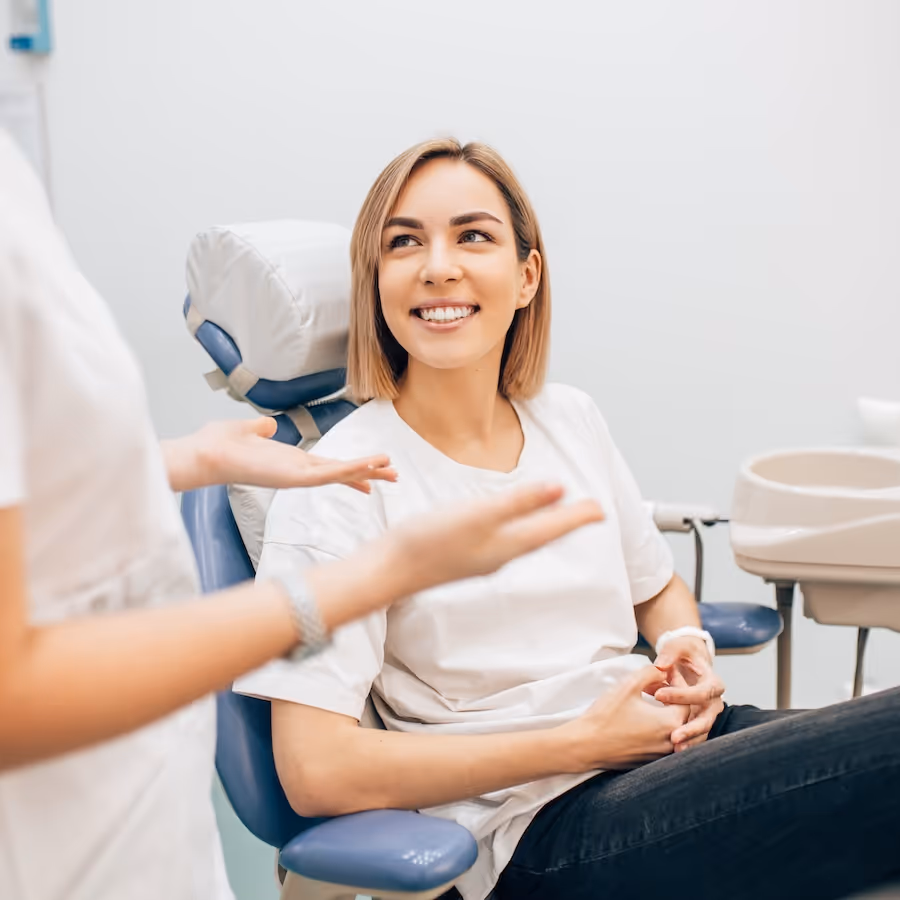 A woman sitting in a dental chair.