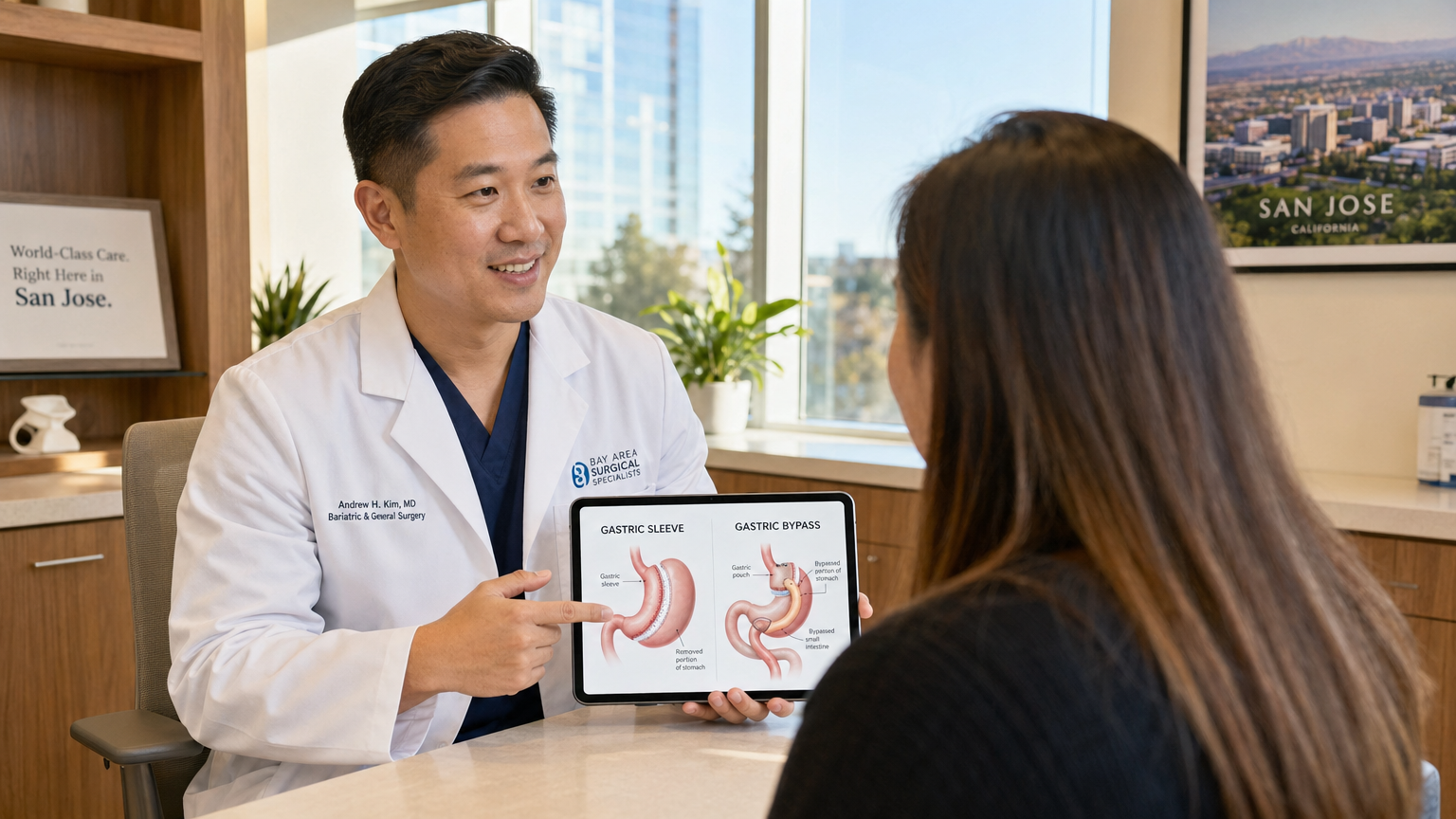 Asian American surgeon showing gastric sleeve vs gastric bypass comparison on tablet to patient in San Jose clinic