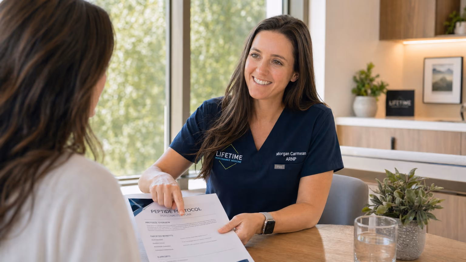 Morgan Carmean, ARNP, reviewing peptide protocols with a patient at Lifetime Surgical