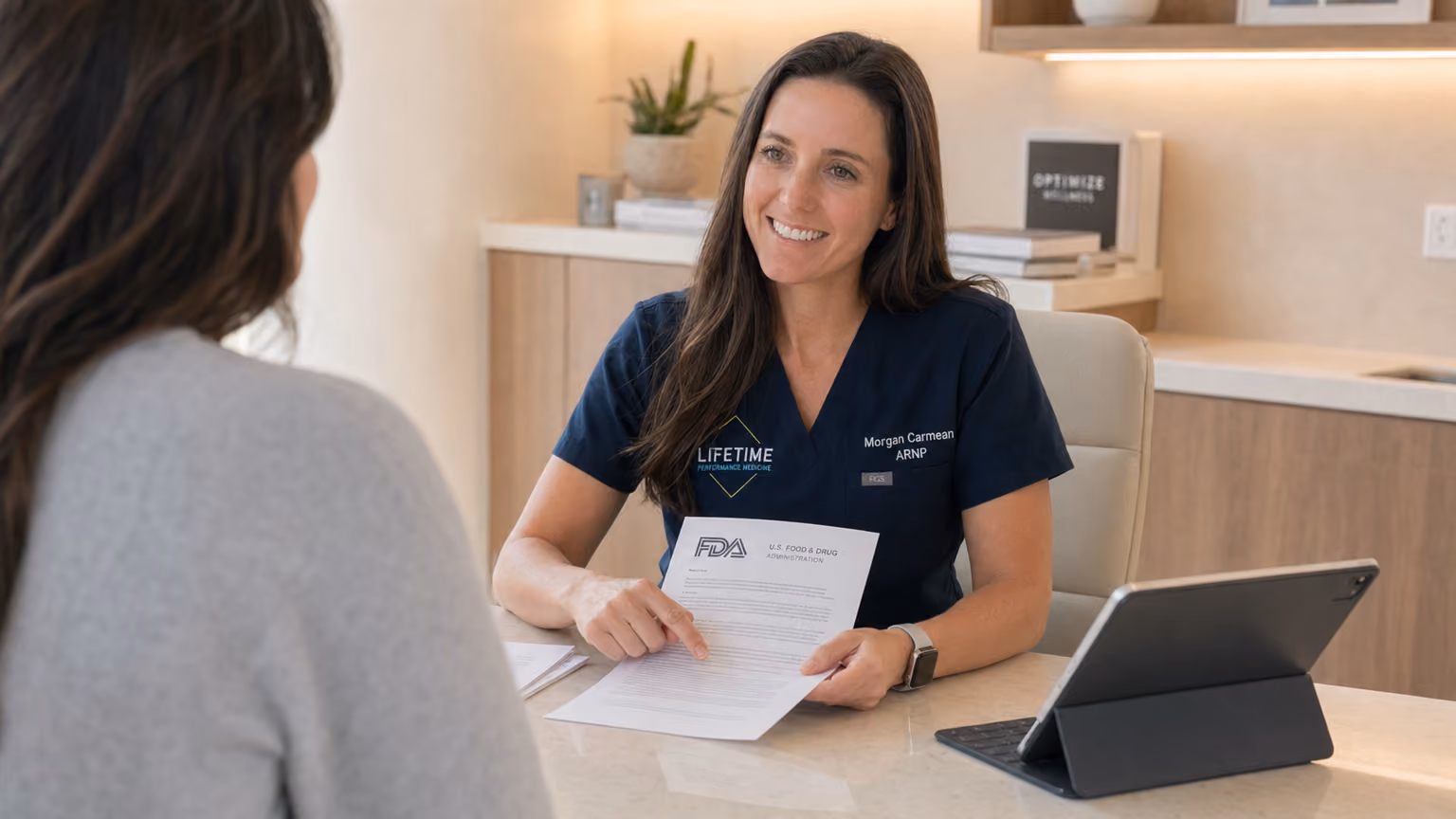 Morgan Carmean, ARNP, reviewing FDA Category 2 peptide documents with a patient at Lifetime Surgical