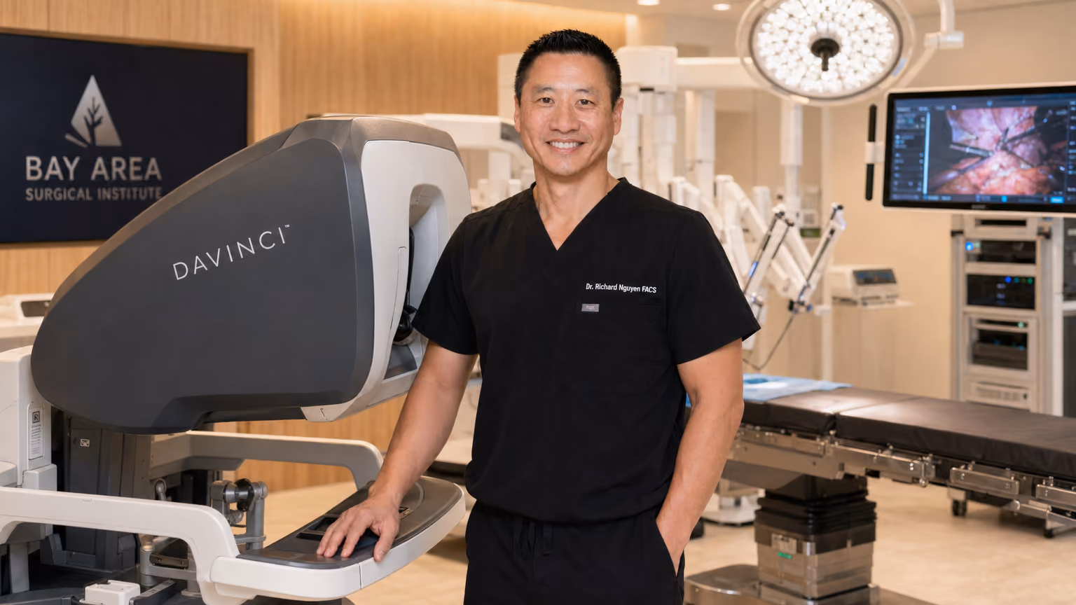 Dr. Richard Nguyen standing with da Vinci robotic surgical system at Lifetime Surgical