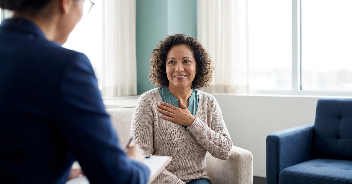 Woman discussing heartburn and hiatal hernia symptoms with a surgeon in a San Jose consultation office