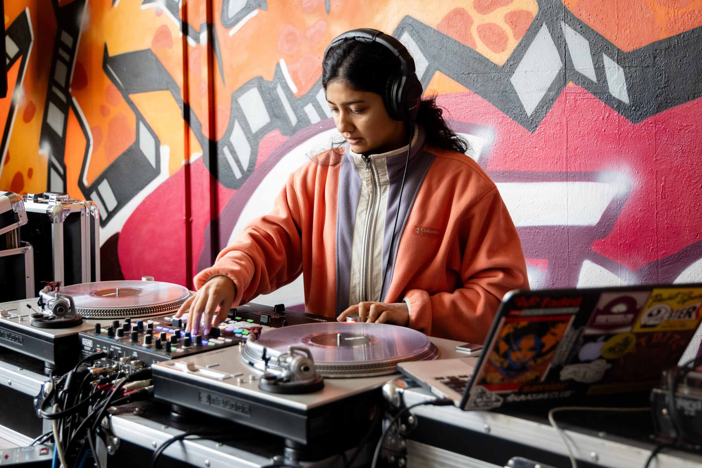 A woman is Djing at an event for Global Hip Hop