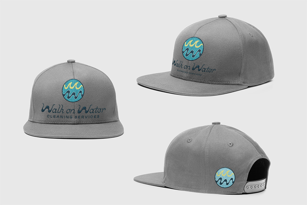 Gray baseball cap with an embroidered circular wave logo and the words 'Walk Water' on the front.