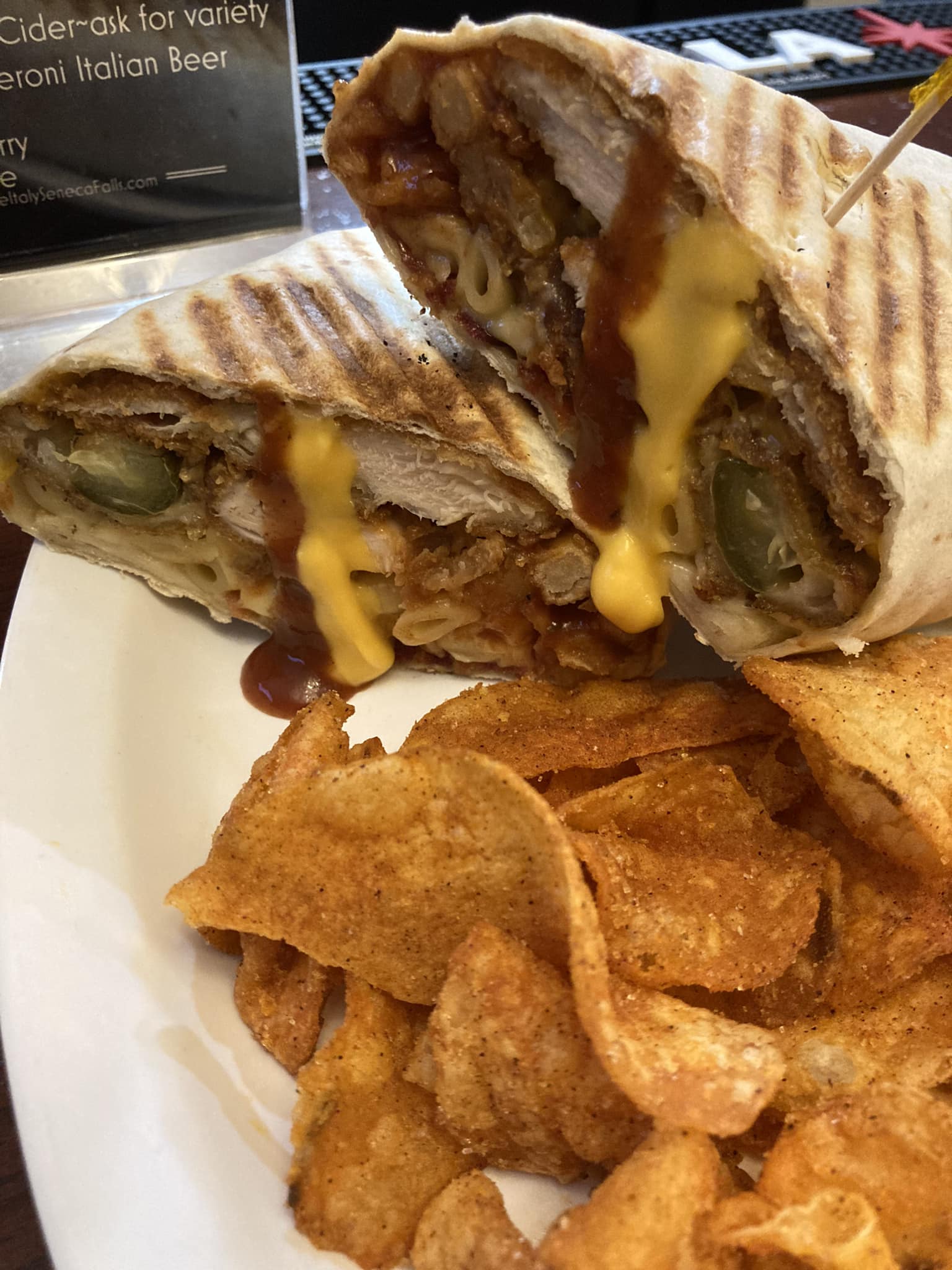 A sandwich with cheese and sauce on a plate.