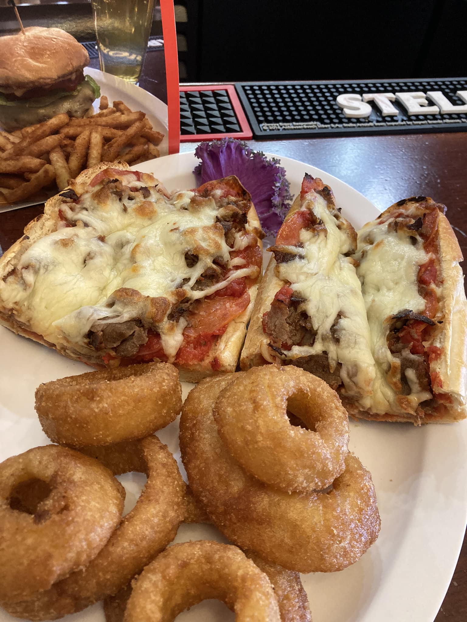 A plate of food with a pizza slice and a donut.