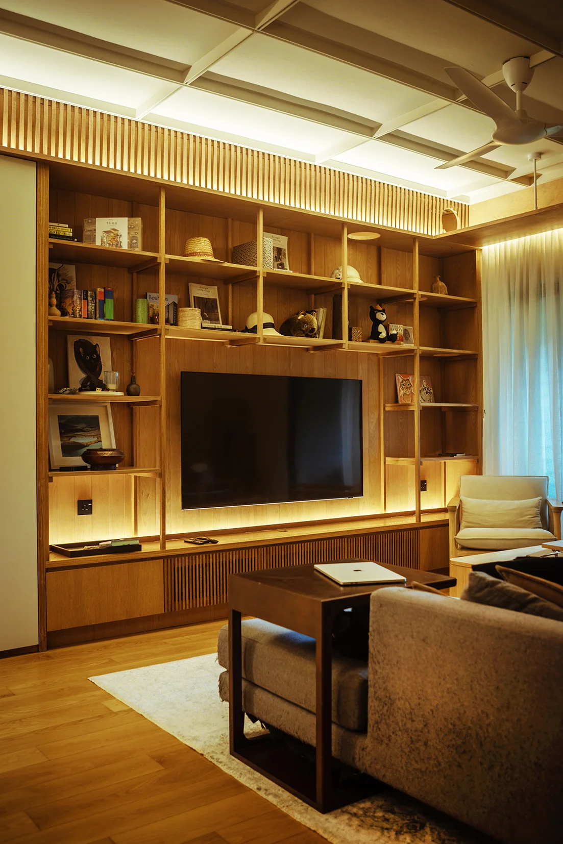 Custom Tanggam wood TV cabinet with integrated cat tunnel.