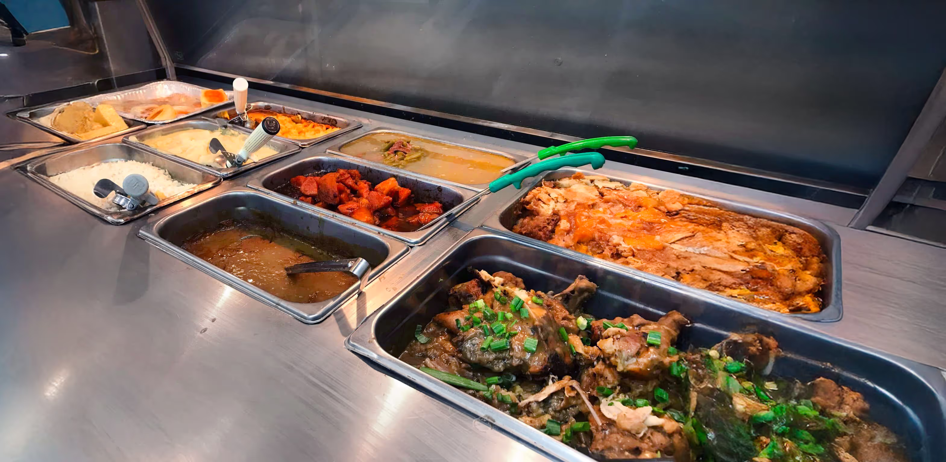 A catering buffet displaying a wide selection of different food dishes.