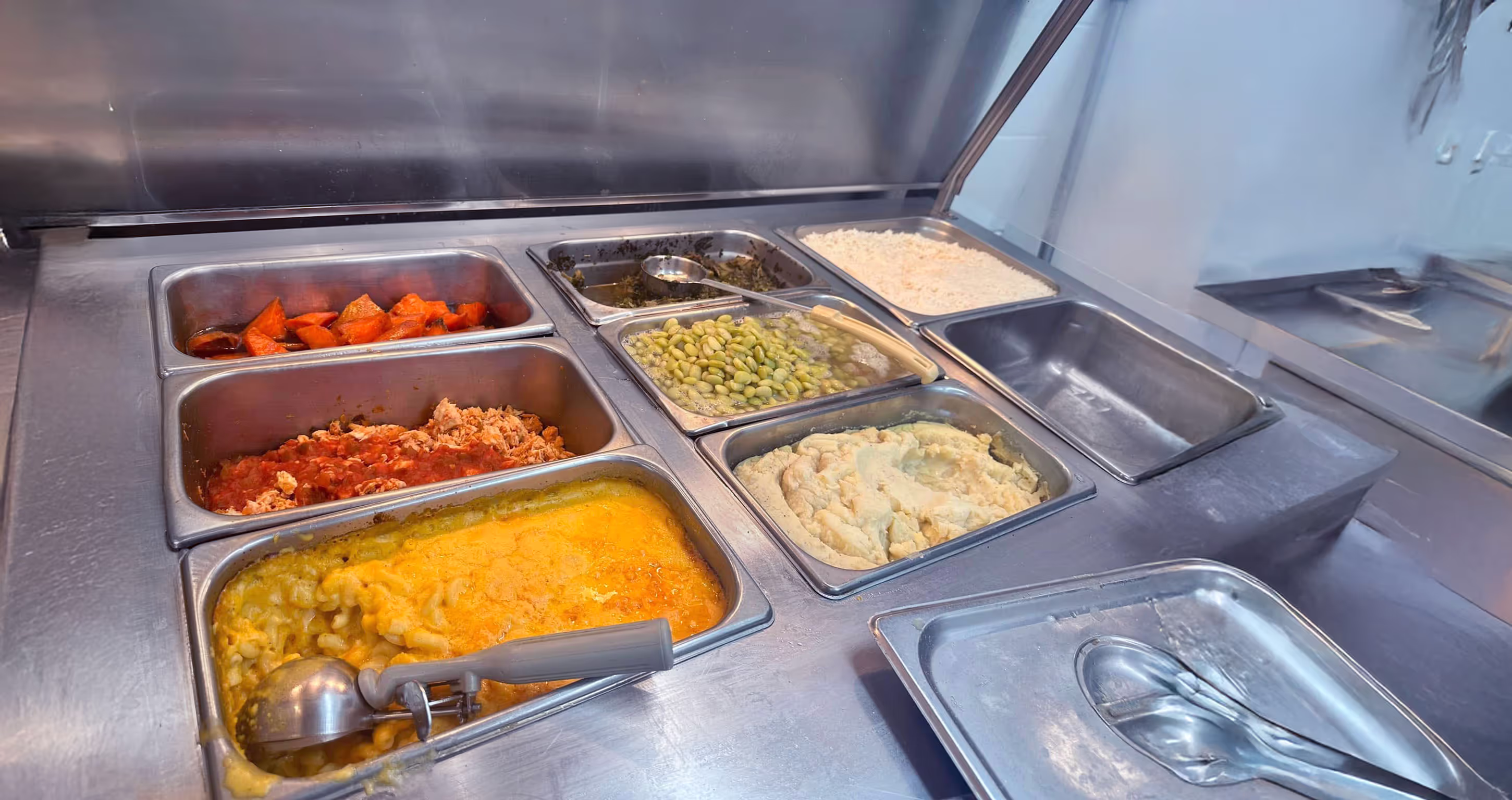 A catering buffet displaying a wide selection of different food dishes.
