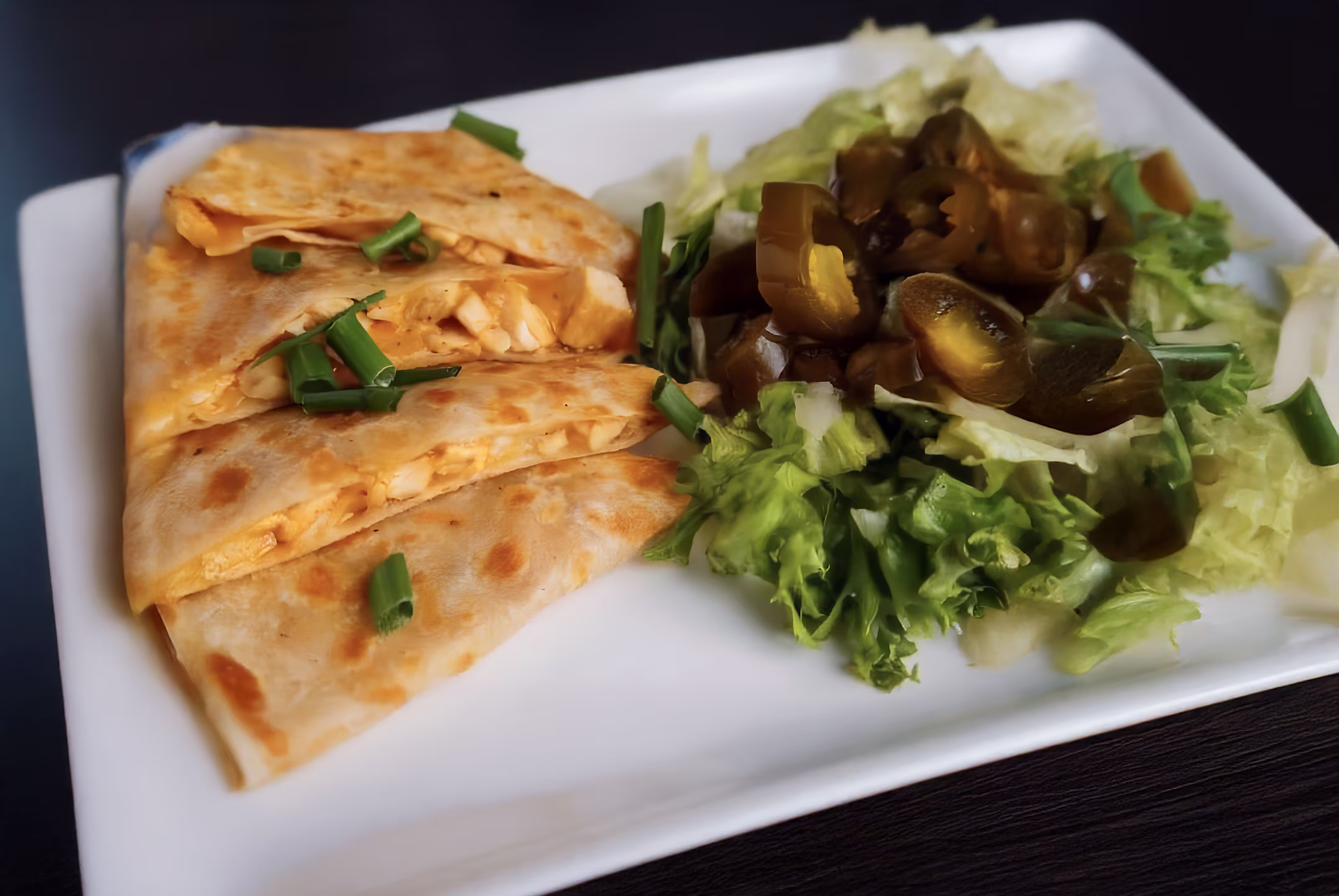 A plate of food, served alongside a colorful salad.