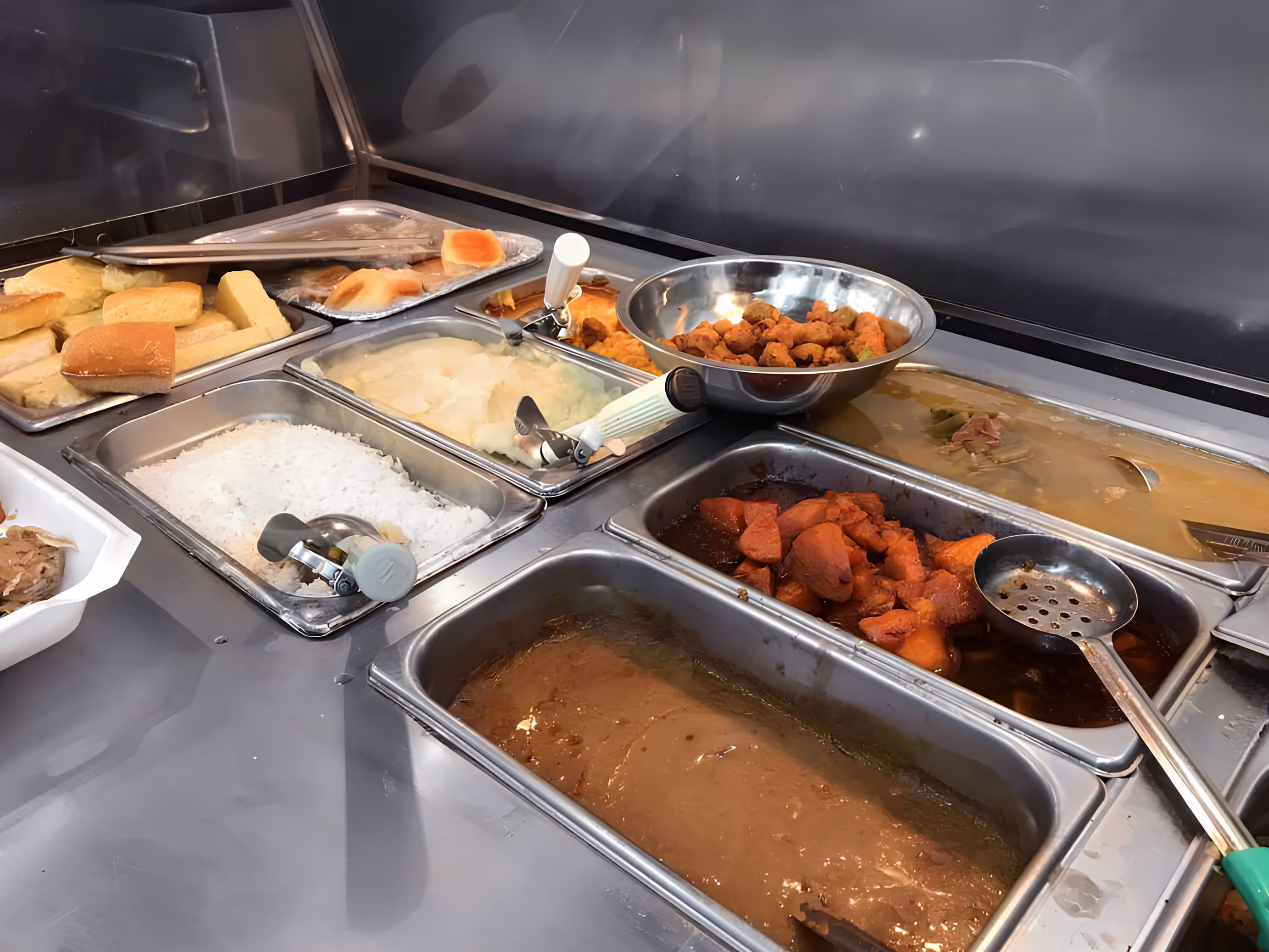 A catering buffet displaying a wide selection of different food dishes.