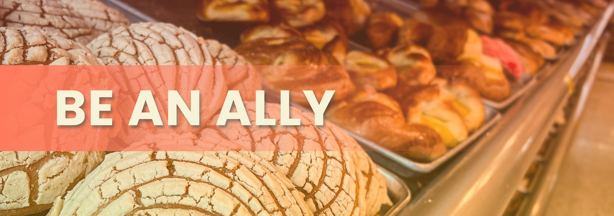Close up of Mexican pastries on a shelf with text "Be an Ally"