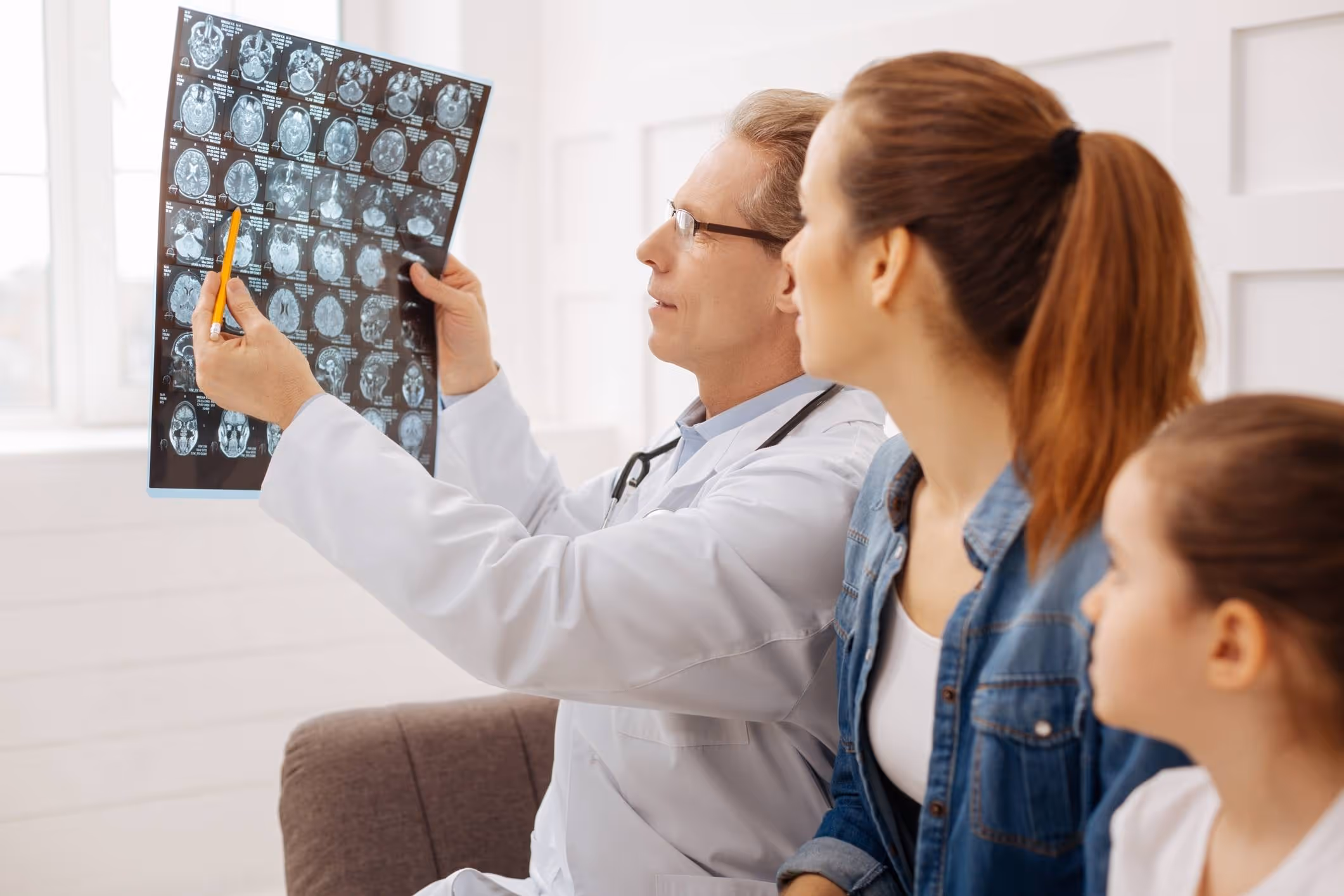 Doctor reviewing MRI scan with patient, discussing can you get a concussion without hitting your head.