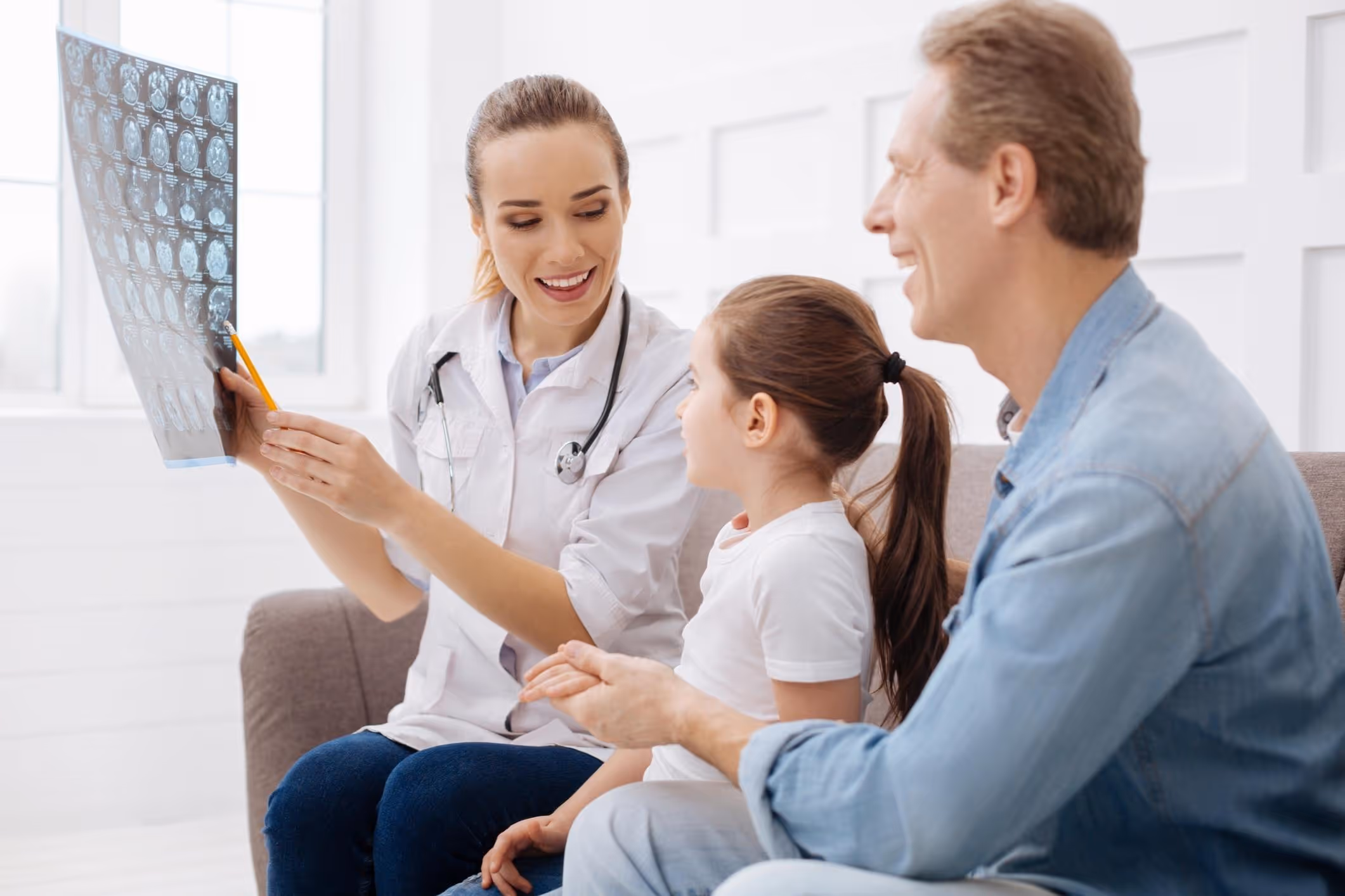 Doctor explaining brain injury, illustrating can a childhood head injury cause problems years later.