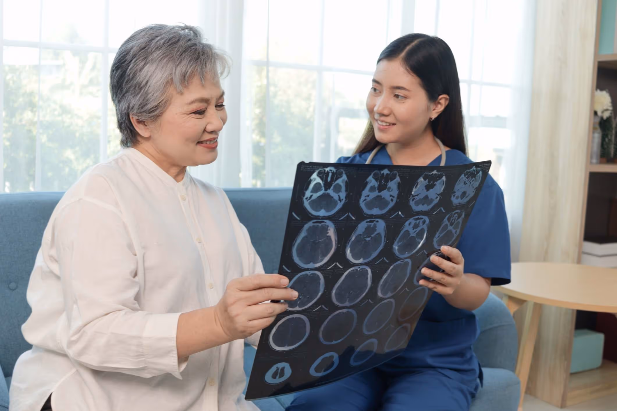 Injured person reviewing brain scan results, thinking what is my traumatic brain injury case worth.