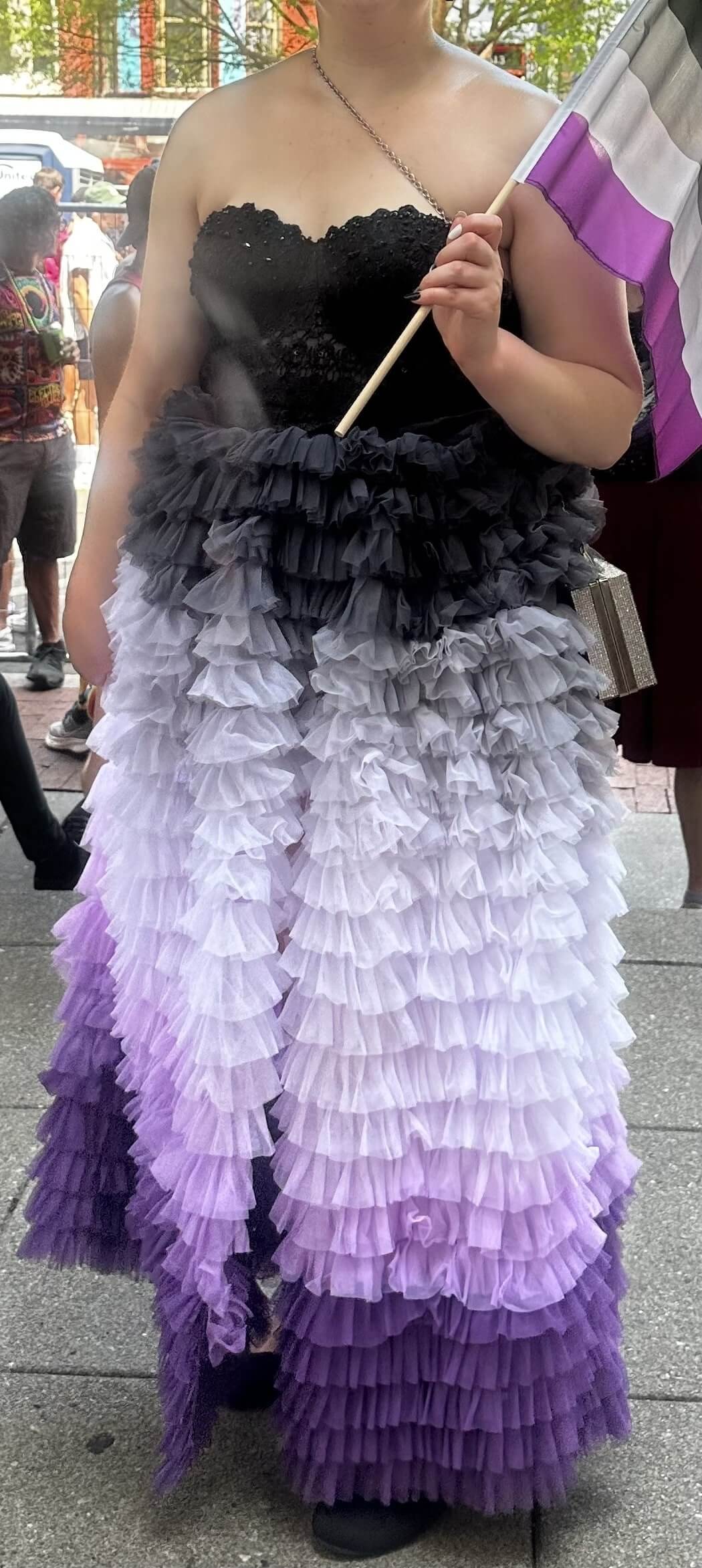 Sierra wearing skirt dyed in the colors of the asexual pride flag