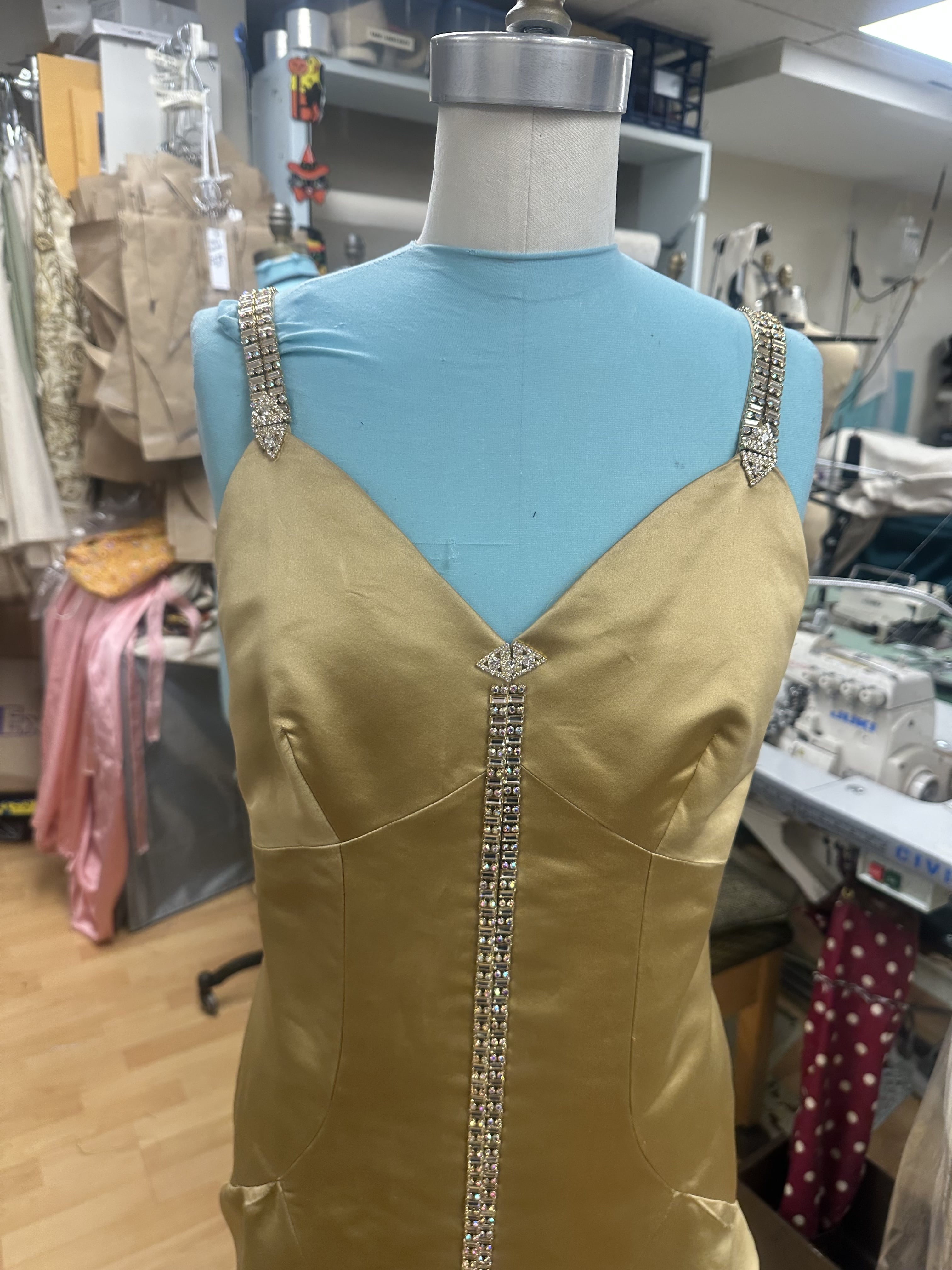 Close up image of the top half of a gold mermaid style dress