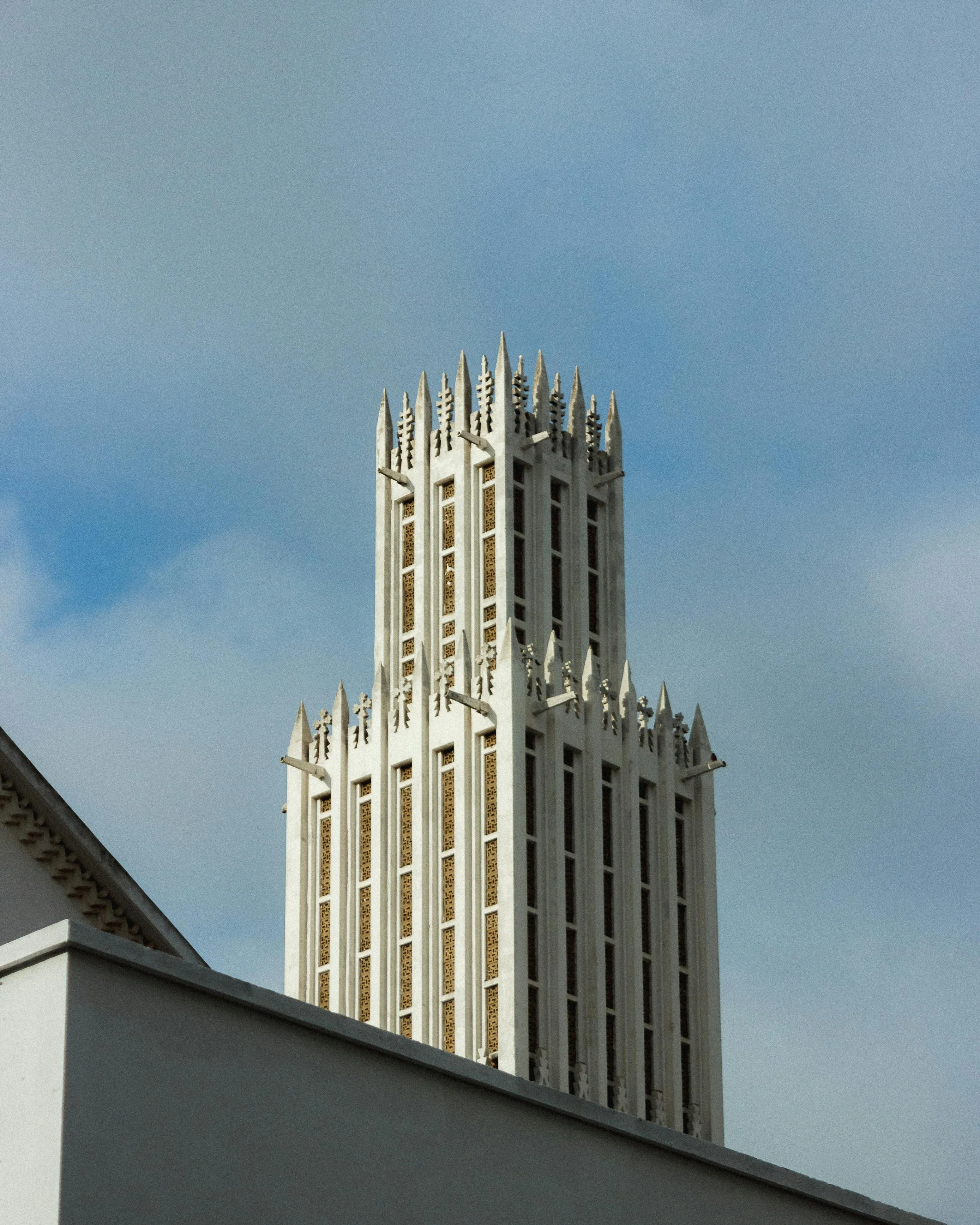A very tall building with a clock on it's side.