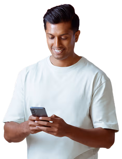 Smiling man in a white t-shirt looking at his smartphone.