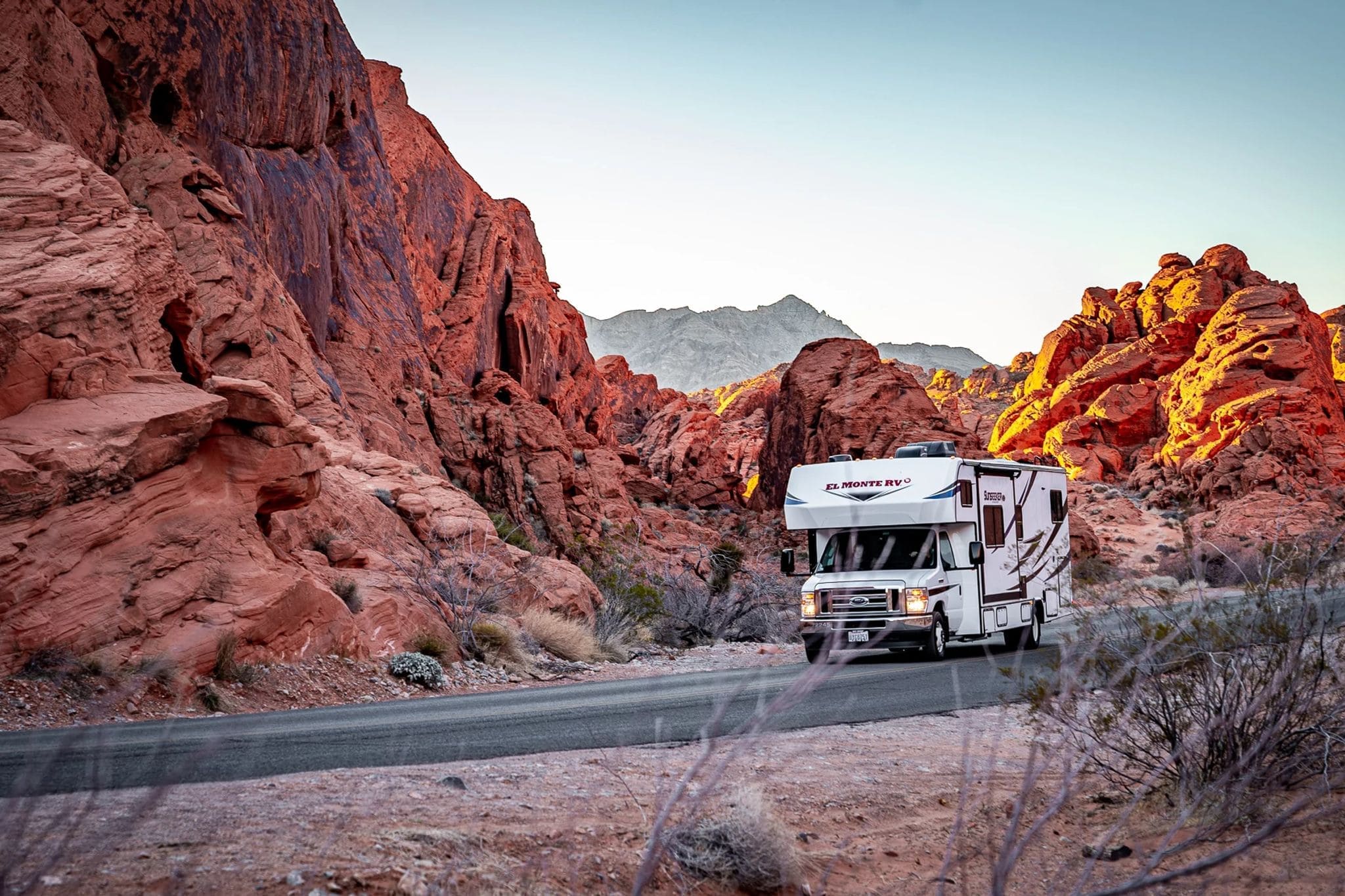 RV driving on the highway towards the Black Rock Desert mountains
