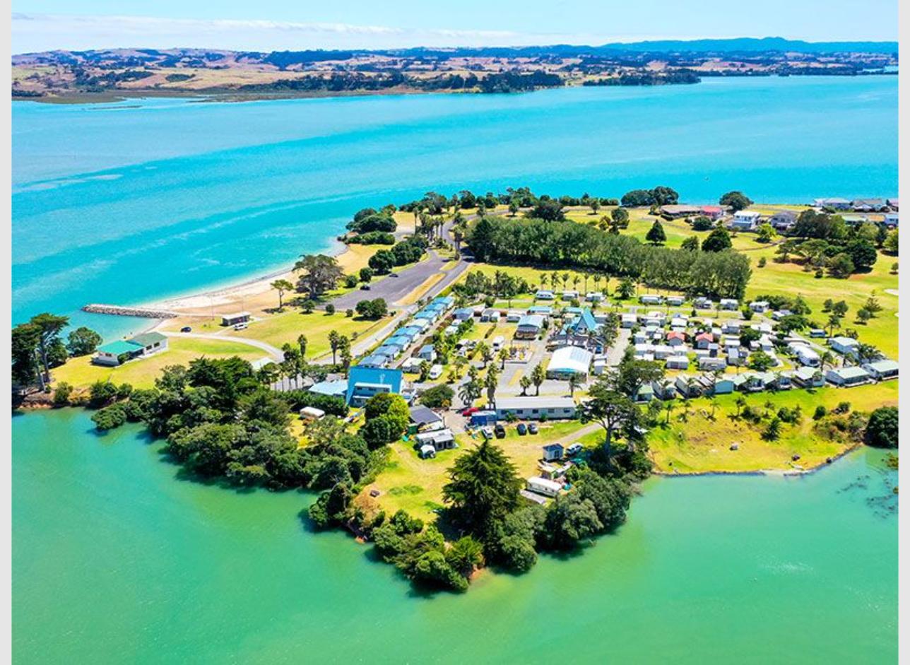 Clarks Beach Holiday Park powered campervan sites overlooking Manukau Harbour near Auckland New Zealand