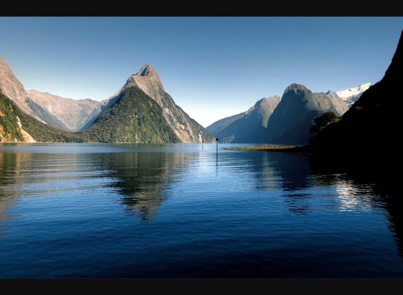 Milford Sound Piopiotahi mountains waterfalls and scenic road from Queenstown for New Zealand motorhome holidays