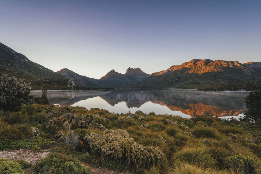 Cradle Mountain peaks reflected in Dove Lake with the historic boatshed
